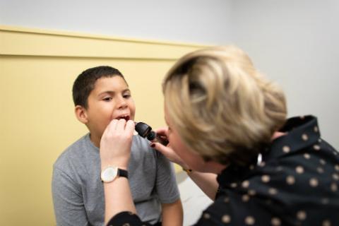 a doctor looking into a child's mouth