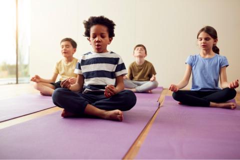 children meditating on yoga mats