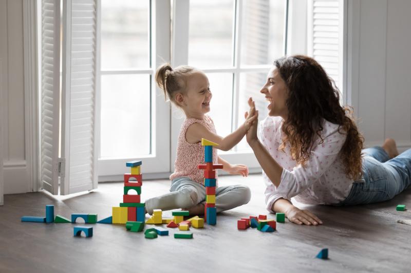 a girl and her mom playing with blocks