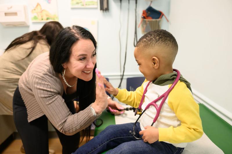 a young boy high fiving a woman