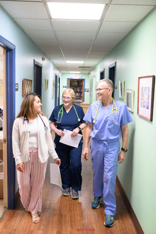 three medical providers walking down a hall