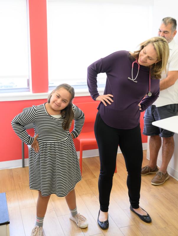 a pediatrician and patient leaning to the left