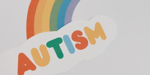 the word autism with a rainbow