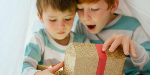 two boys unwrapping a present together