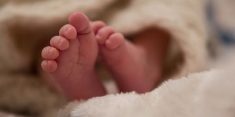 baby feet peeking out of a blanket