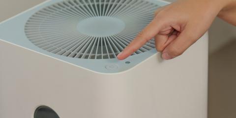 a hand pointing to a humidifier