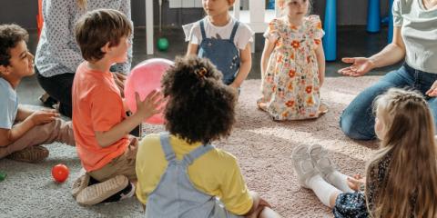 a group of children and adults in a circle